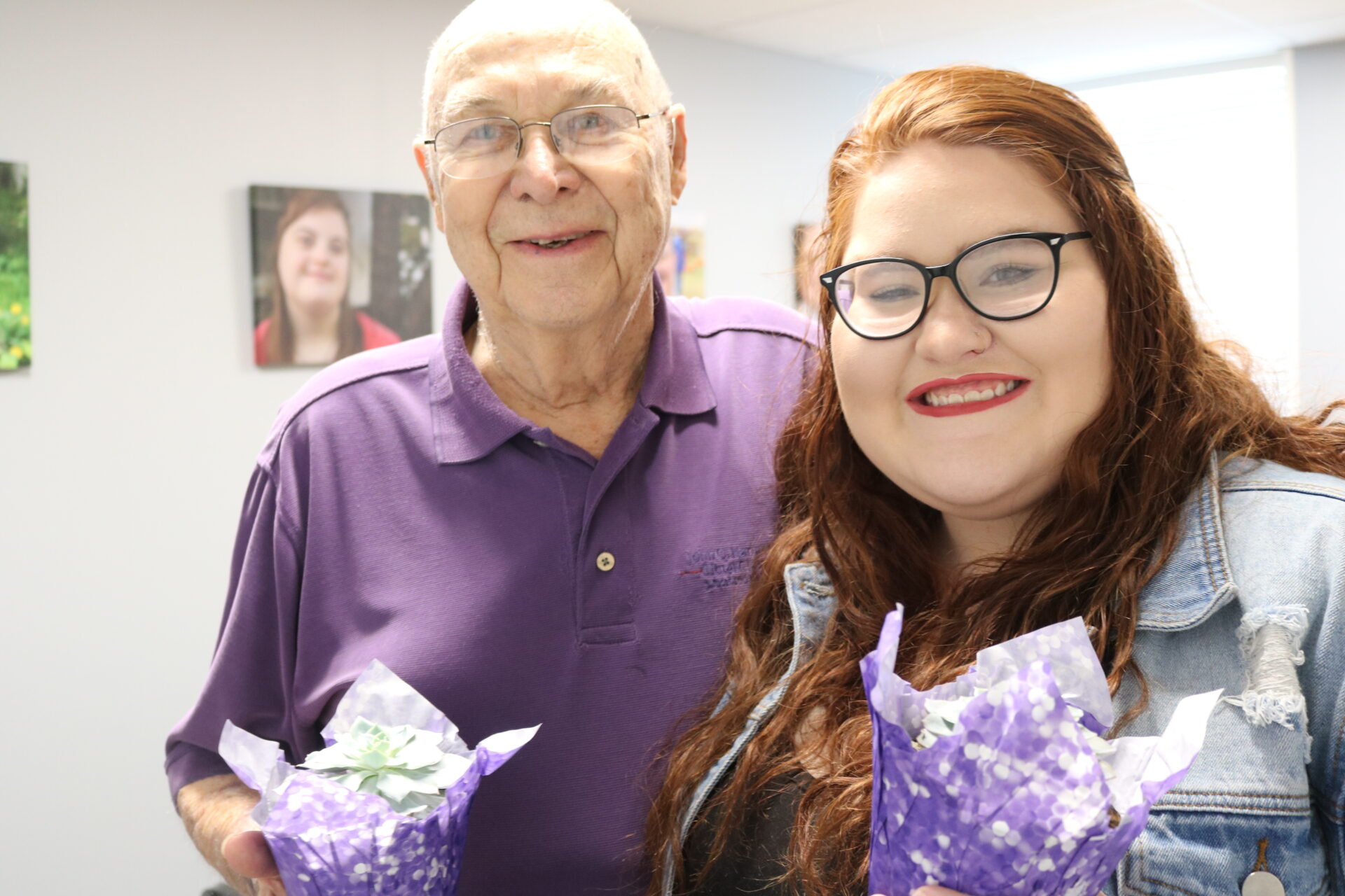 An older gentlemen and younger woman, both volunteers.