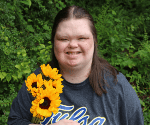 a person holding sunflowers