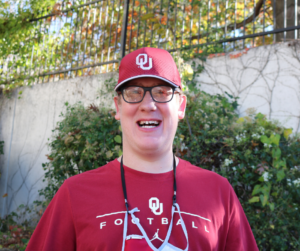 a person with eyeglasses wearing a red hat and shirt