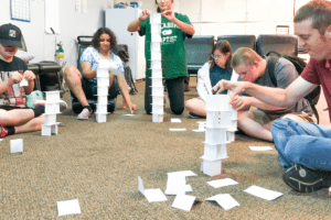 Students stacking cards to make towers