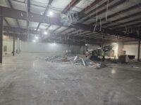 Another image of the bare building with no ceiling and debrief everywhere.