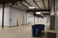 A photo a wall and empty warehouse space