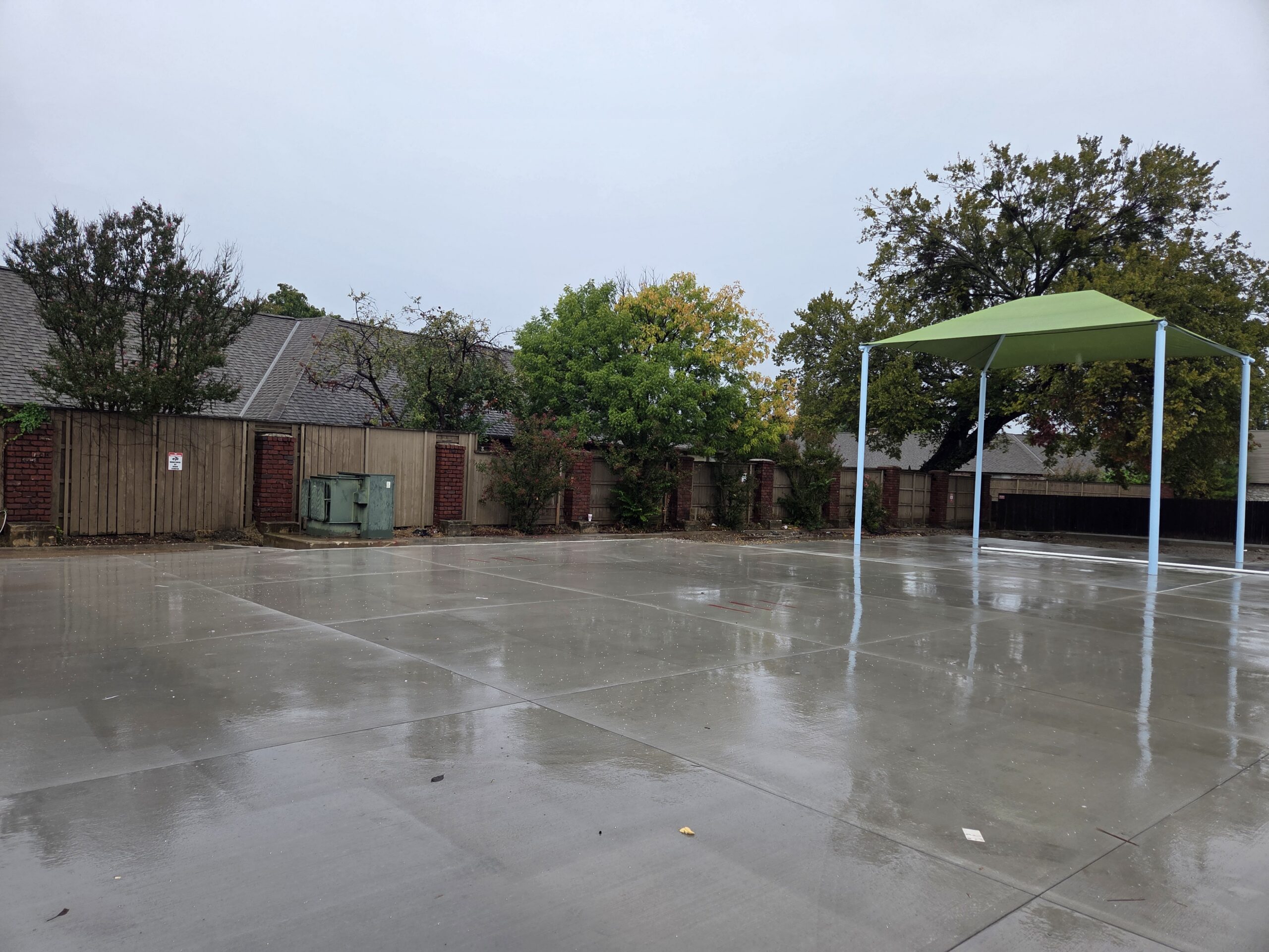 The outdoor classroom with a shade covering and completed concret